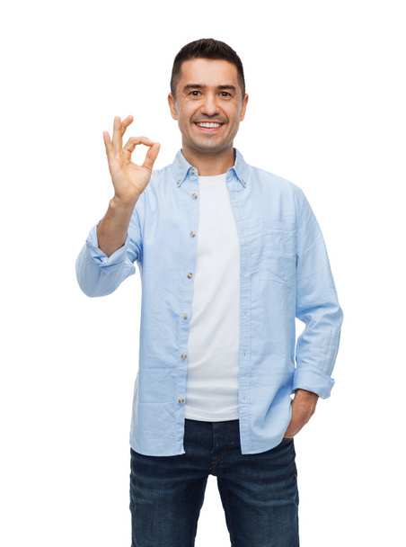 smiling man showing ok hand sign - Foto, immagini
