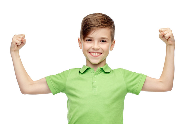 happy boy in polo t-shirt showing strong fists - Foto, imagen