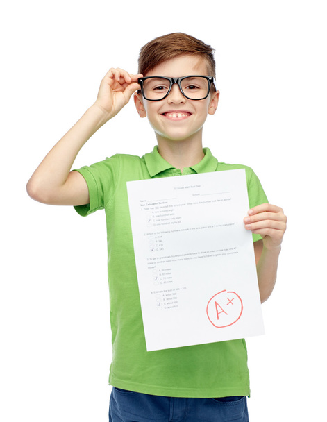 happy boy in eyeglasses holding school test result - Фото, зображення
