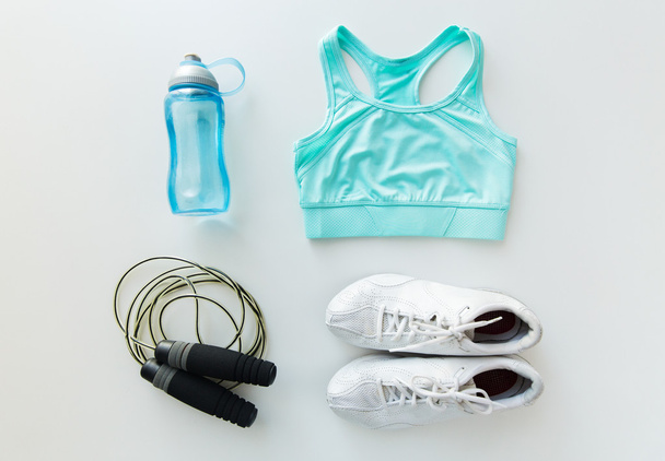 close up of sportswear, skipping rope and bottle - Photo, image