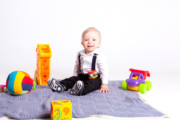 Boy with toys on white background - Фото, изображение