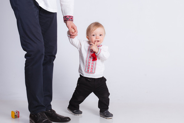 Little boy holding father hand on white - Photo, image