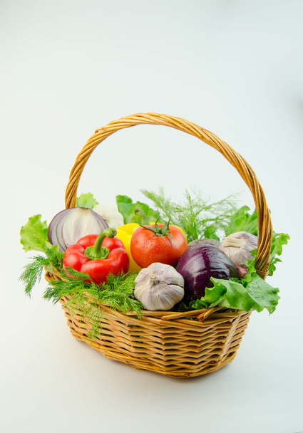 Vegetables and herbs in a wicker basket - Fotó, kép