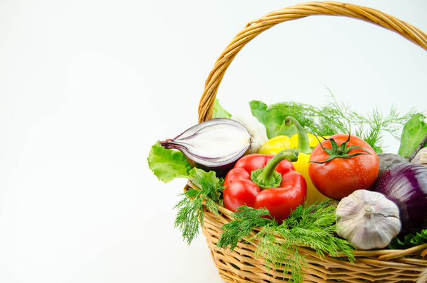 Vegetables and herbs in a wicker basket - Fotó, kép
