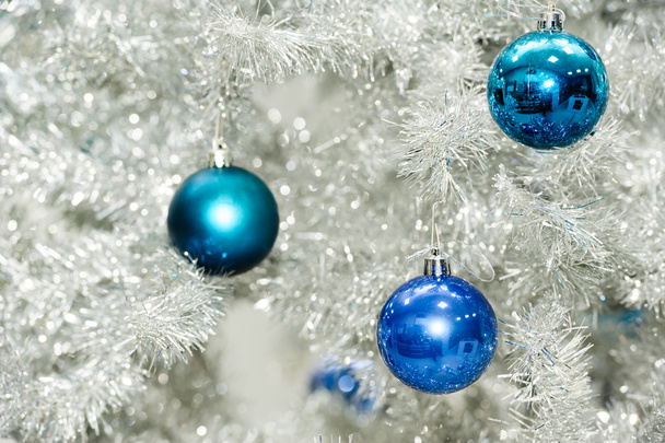 Blue baubles on silver artificial christmas tree - Photo, Image