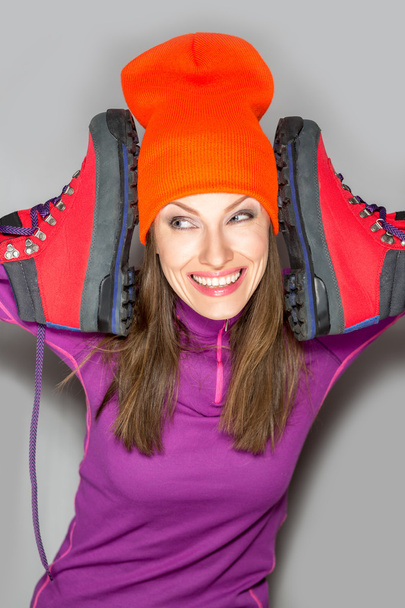 Beautiful sport woman traveler holding trekking boots - Φωτογραφία, εικόνα