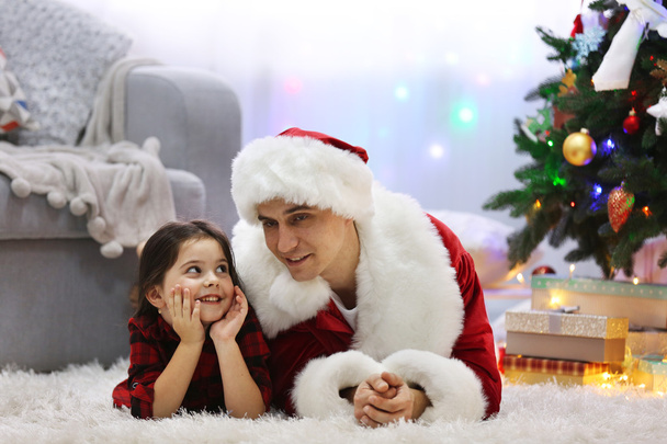Happy father and daughter in Christmas room - 写真・画像