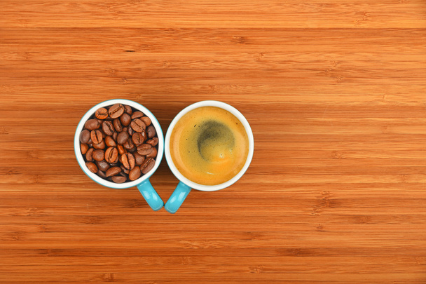 Kaksi kahvikuppia espresso ja pavut puusta tausta
 - Valokuva, kuva