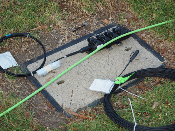 Road side communications pit with prepared green feeder cable, 8 port multiport and drop cable - Photo, Image