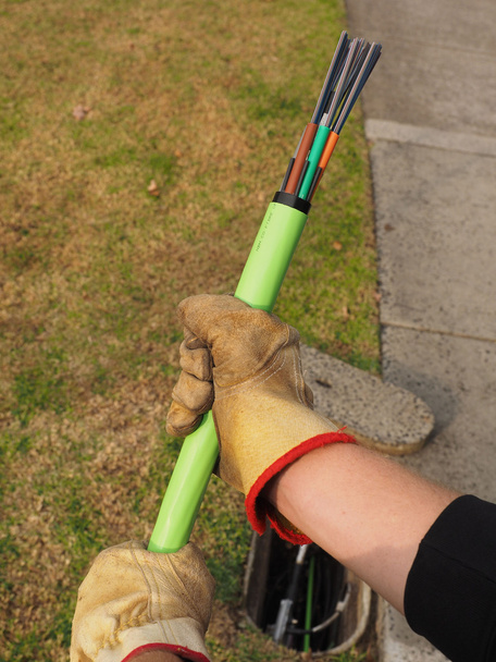 Cable installer holding fiber optic cable - Photo, Image