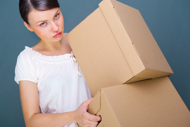 Close-up portrait of a young woman with boxes - Photo, Image