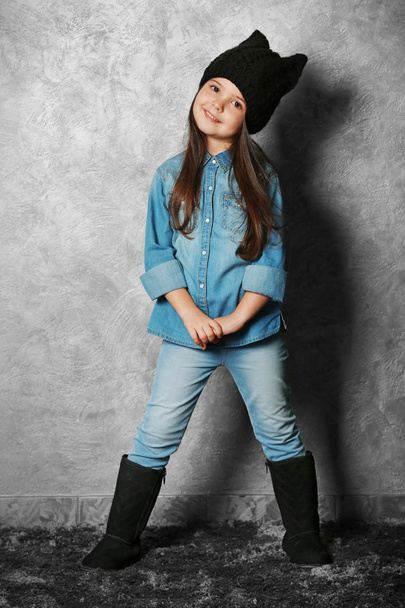 Portrait of little fashion kid girl on gray wall background - Photo, Image