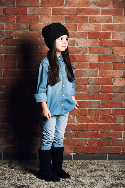 Portrait of little fashion kid girl on bricks wall background - Фото, зображення