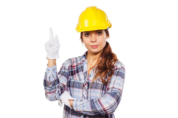 Jovem mulher em capacete de construção amarelo
  - Foto, Imagem