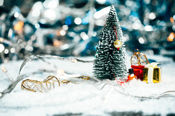 miniature Christmas tree, snowman and gifts in the snow - Φωτογραφία, εικόνα