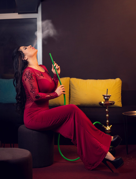 Woman smoking hookah in bar - Φωτογραφία, εικόνα