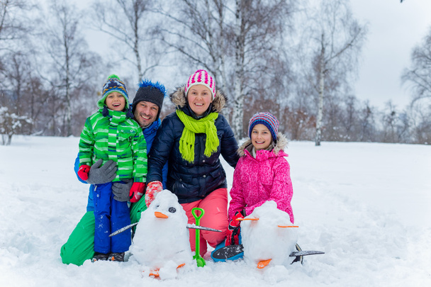 Family with a snowman - Foto, afbeelding