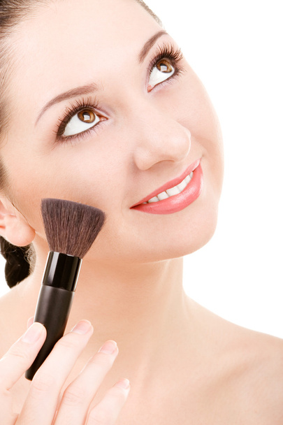 Pretty young woman with a make-up brush - Fotoğraf, Görsel
