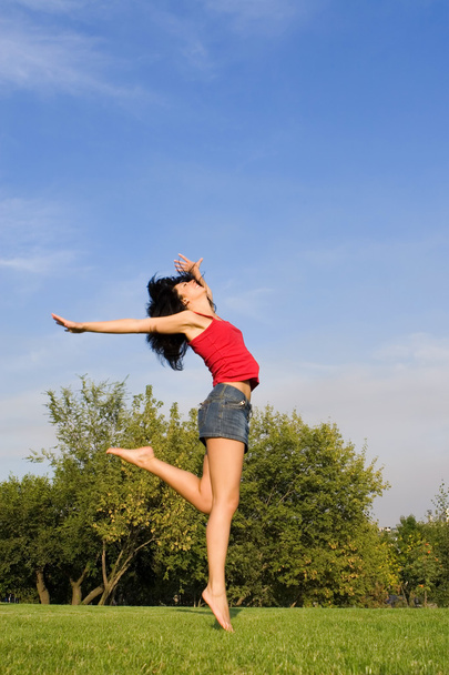 Pretty young woman is jumping - 写真・画像