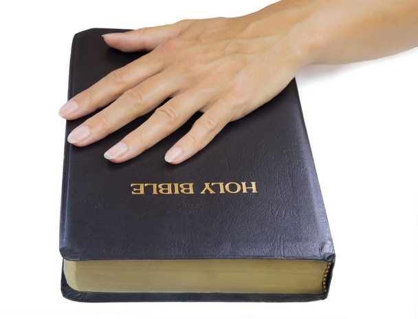 Жінка руки над Святою Біблією
 - Фото, зображення