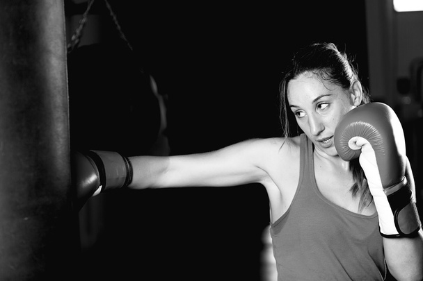 Женщины-боксеры практикуют удары на боксерской груше
 - Фото, изображение