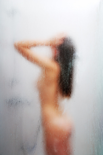 Nude woman in the shower cabin - 写真・画像