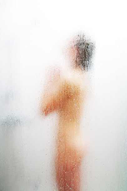 Female silhouette through the weeping glass - Фото, зображення