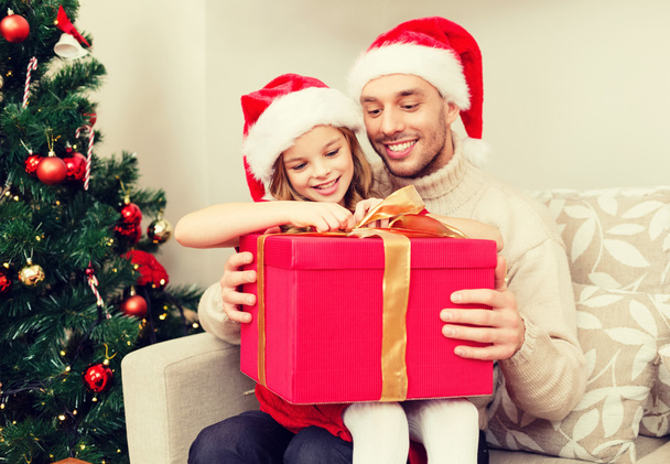 smiling father and daughter opening gift box - Photo, image