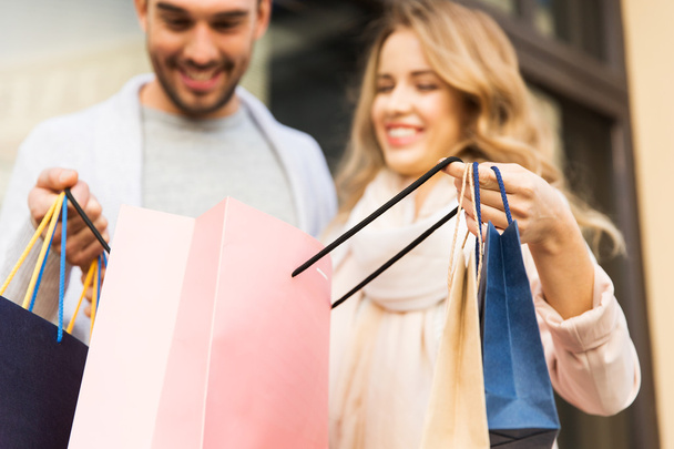 close up of couple with shopping bags on street - Photo, image