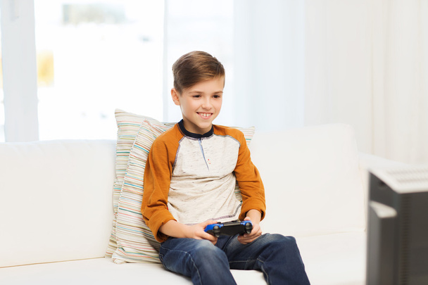 happy boy with joystick playing video game at home - Photo, image