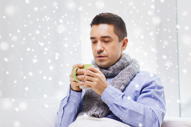 ill man with flu drinking hot tea from cup at home - Photo, image