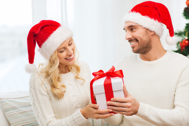 happy couple at home with christmas gift box - Photo, image