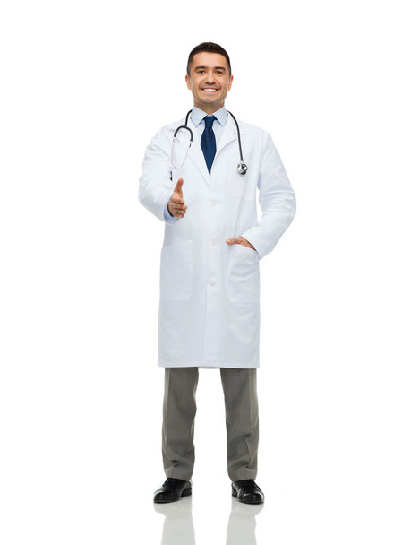 smiling doctor in white coat making handshake - Photo, Image