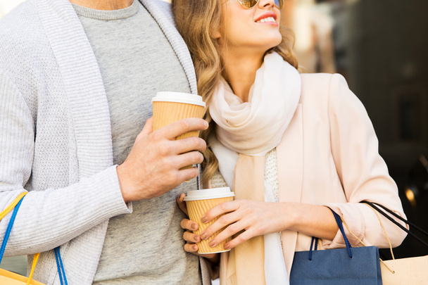 close up of couple with shopping bags and coffee - Foto, immagini