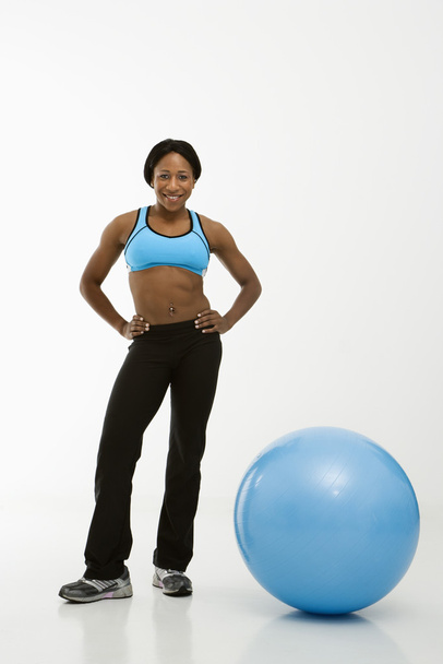 Woman standing with exercise ball. - Valokuva, kuva
