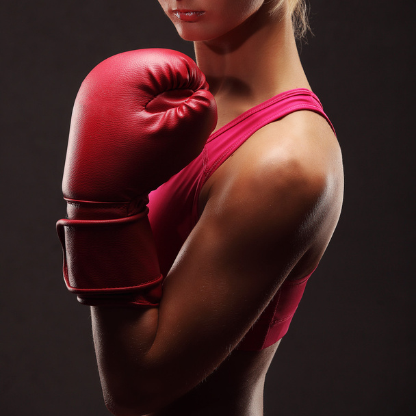Young sexy girl over black background with boxing gloves - Foto, imagen