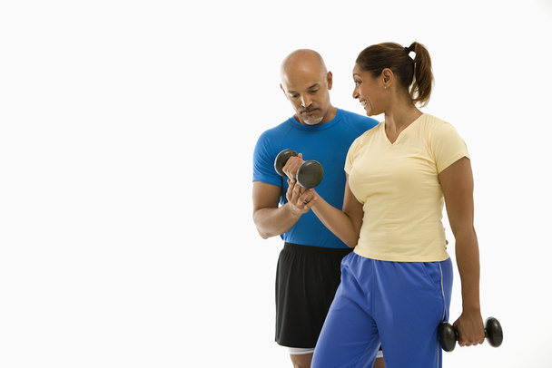 Woman and man exercising. - Фото, изображение