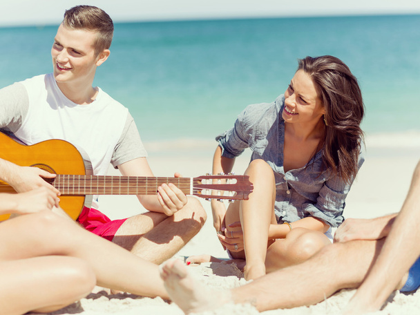 Beautiful young people with guitar on beach - Zdjęcie, obraz