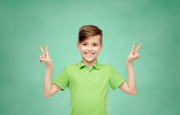 school boy showing peace or victory hand sign - Valokuva, kuva