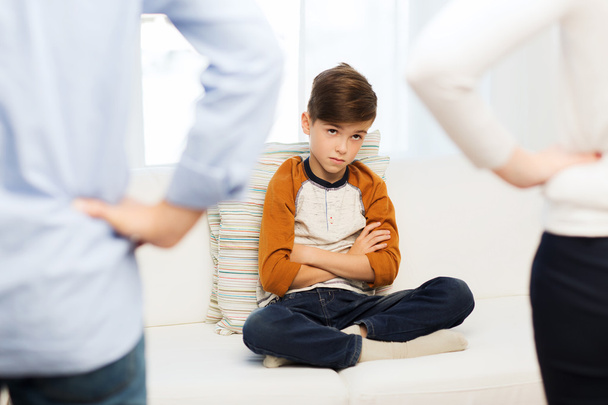upset or feeling guilty boy and parents at home - 写真・画像