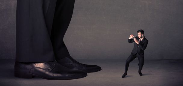 Huge legs with small businessman standing in front concept - 写真・画像