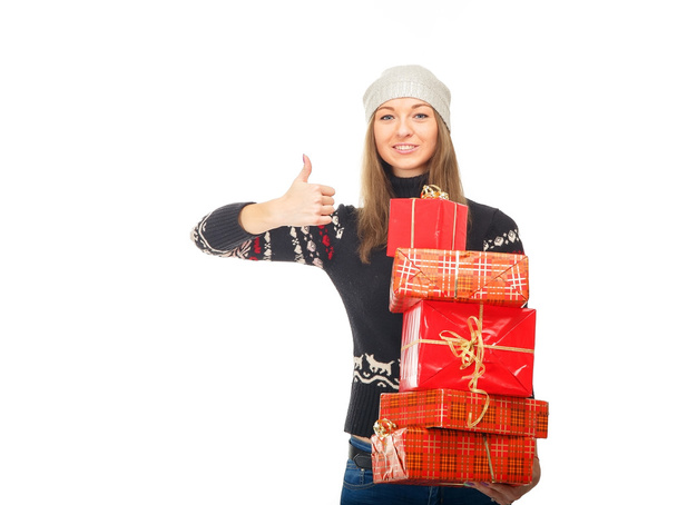 Woman in a winter sweater holding boxes with gifts. - Foto, immagini