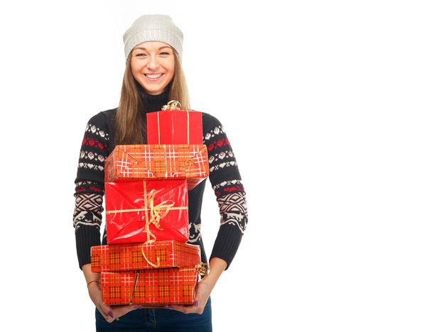 Woman in a winter sweater holding boxes with gifts. - Photo, Image