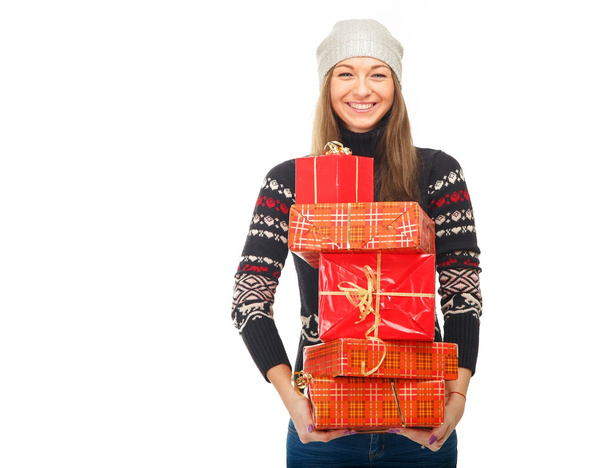Woman in a winter sweater holding boxes with gifts. - Φωτογραφία, εικόνα
