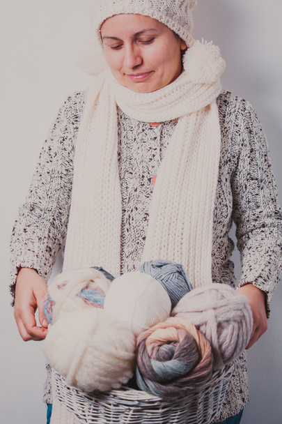Woman with basket of balls woolen yarn - Фото, зображення