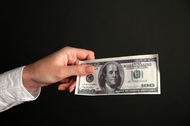 Woman burning dollars on black background - Photo, Image