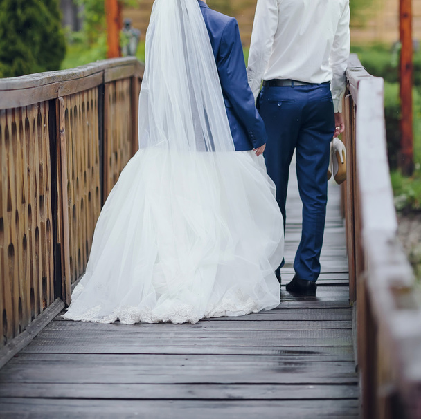 bride and groom posing together outdoors on a wedding day - Фото, изображение