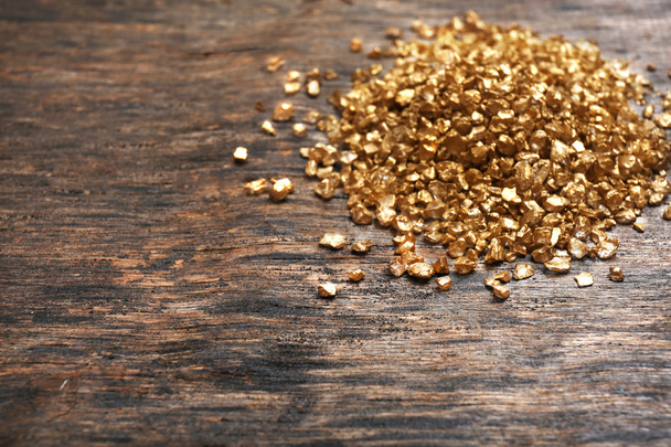 A pile of Gold nugget grains, on wooden background - Фото, зображення