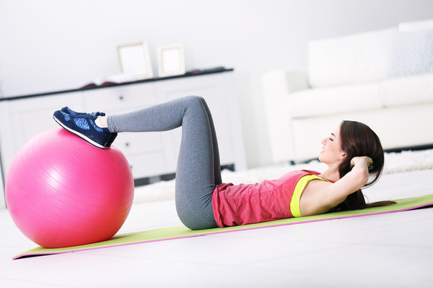 girl doing exercises with fit ball - 写真・画像