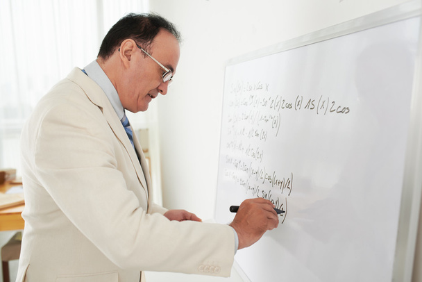 Male teacher writing trigonometric formulas - Photo, Image